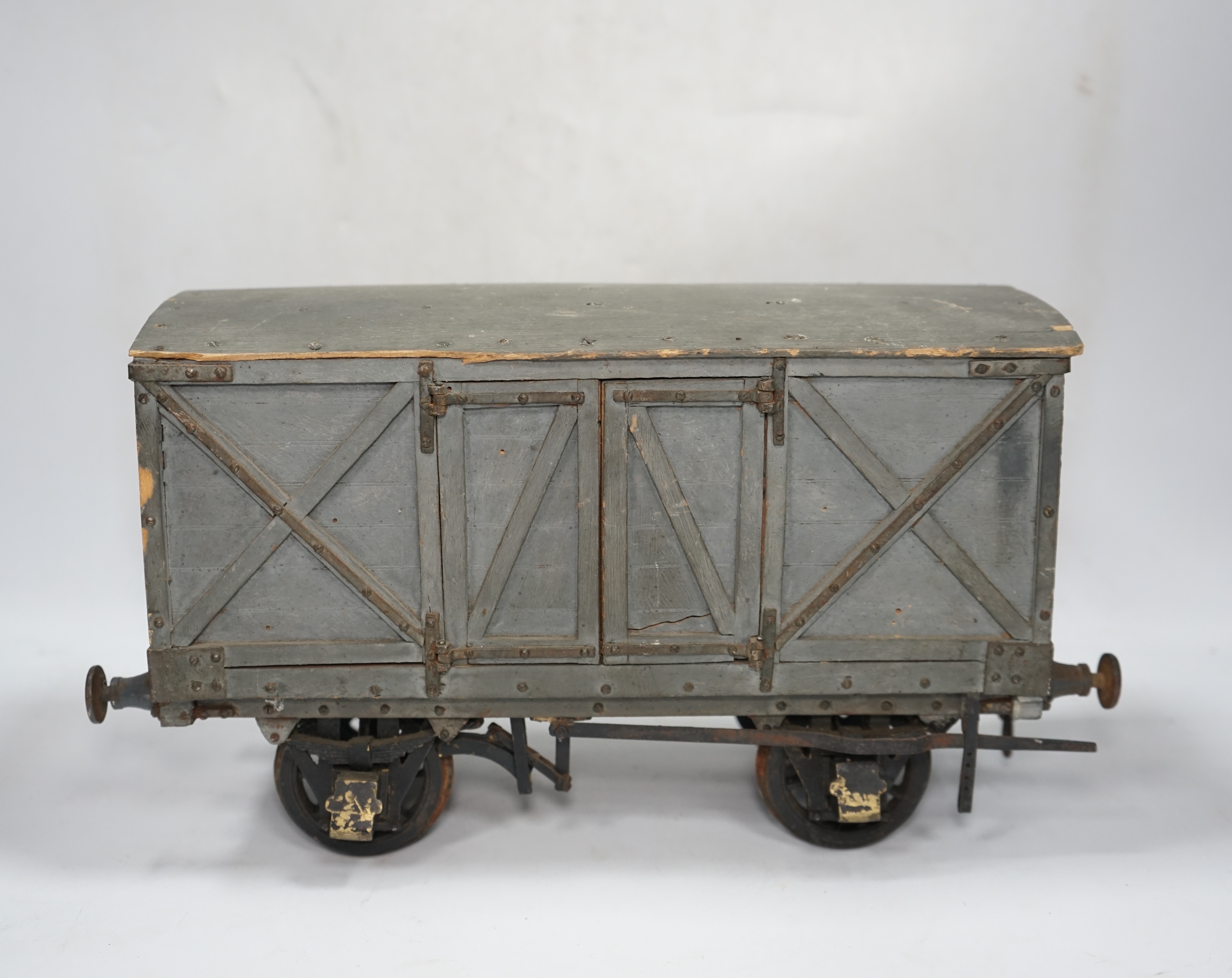 A 1950s/60s 3.5 inch gauge model railway box van, scratch built of plywood construction, with opening doors on both sides, 33cm long over the buffers, 18.5cm high. Condition - poor to fair, one buffer missing, springs mi